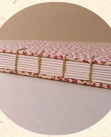 Tranche d'un carnet relié en reliure Copte avec couture apparente en chaînette dorée - Cosette Cartonera